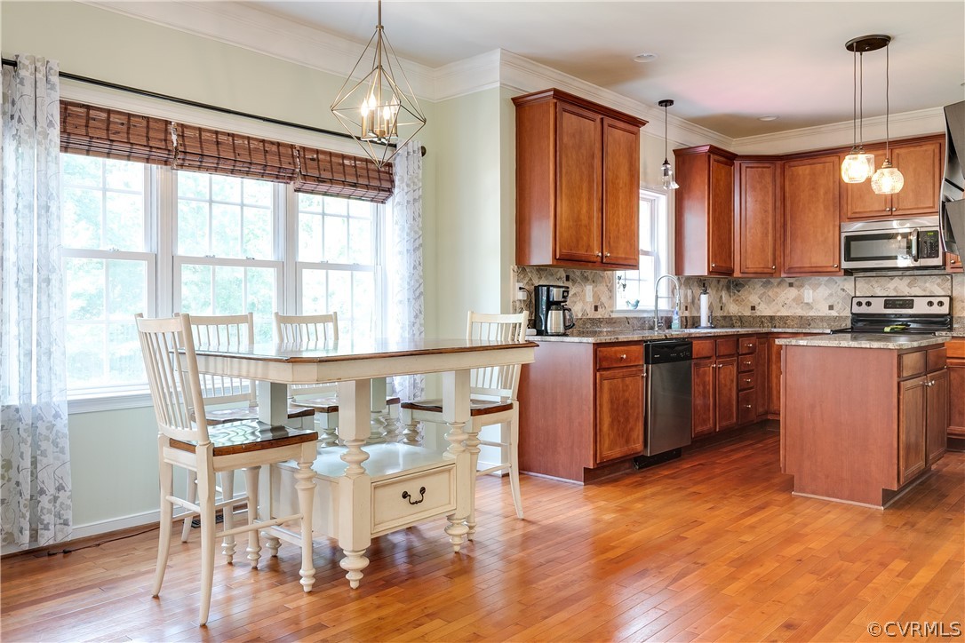 9518 Dunroming Road Chesterfield, VA 23832 - Photo 9 of 47 a open kitchen with stainless steel appliances granite countertop a stove top oven a sink dishwasher a dining table and chairs with wooden floor