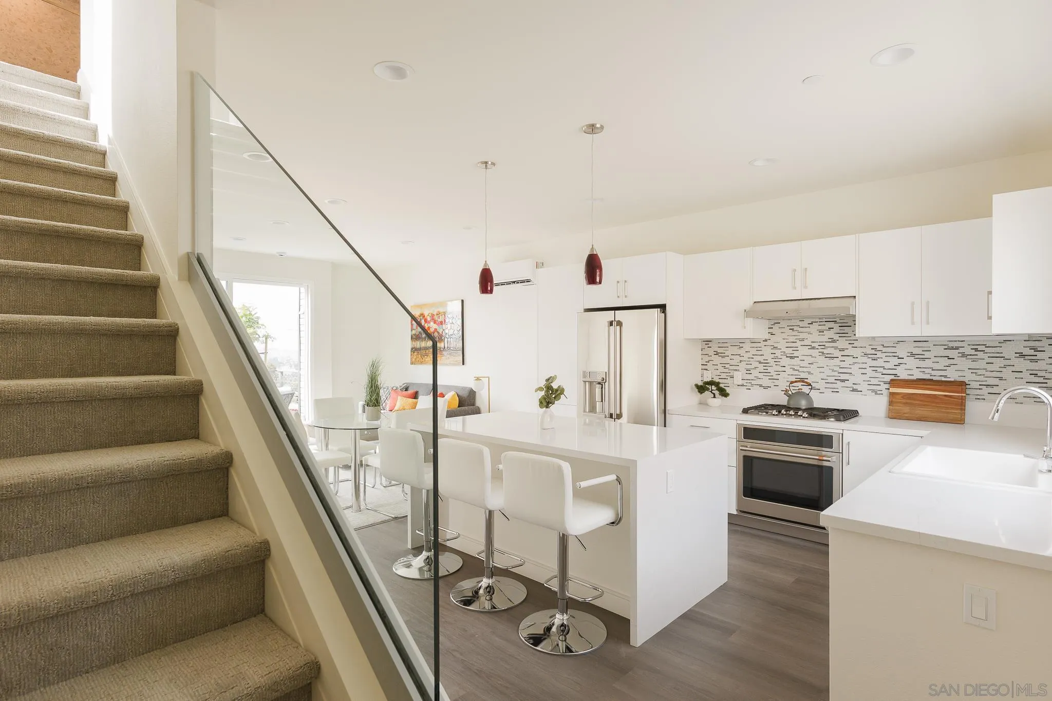 8286 High Street La Mesa, CA 91941 - Photo 12 of 27 a kitchen with white cabinets and white appliances