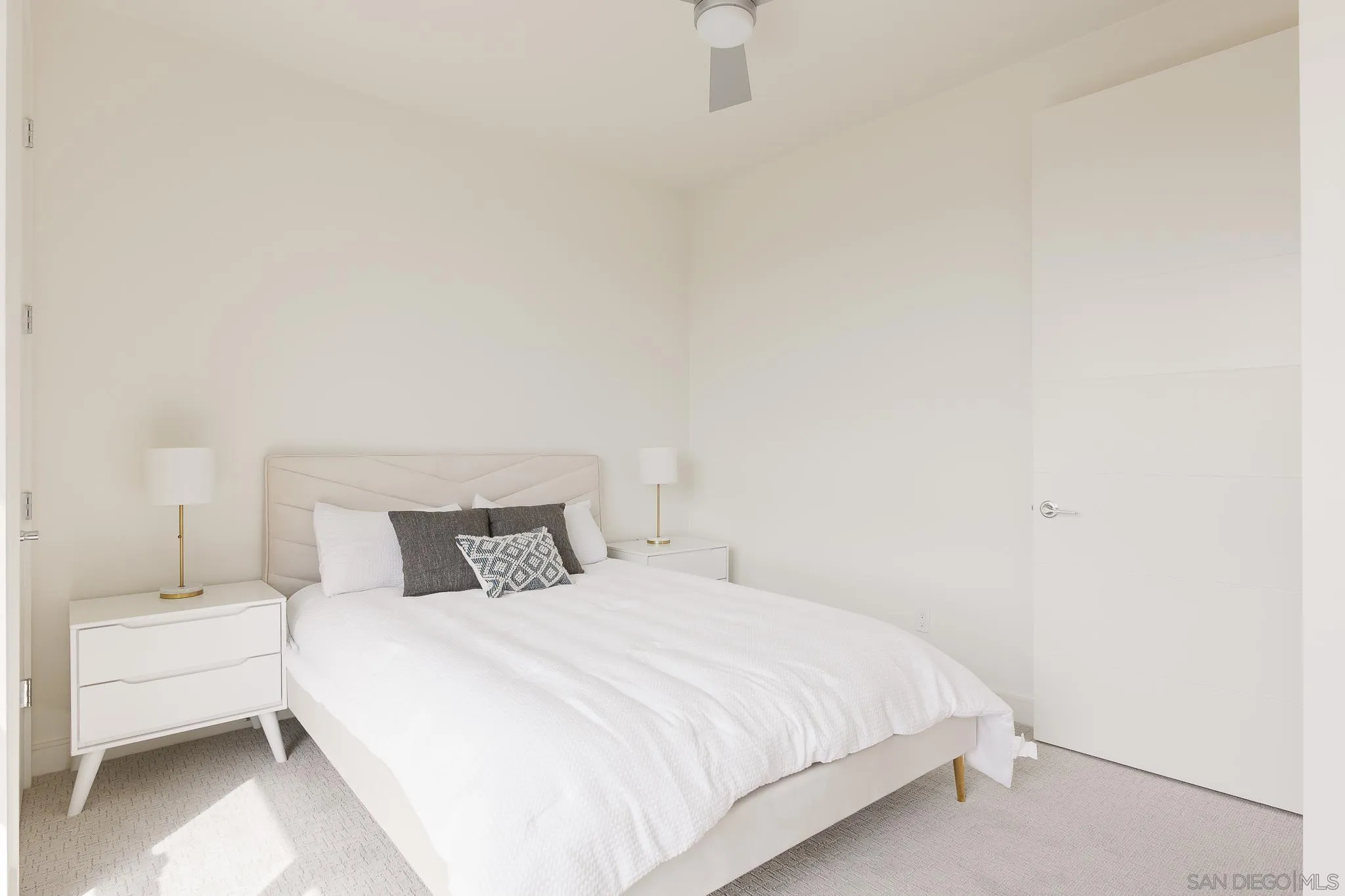 8286 High Street La Mesa, CA 91941 - Photo 14 of 27 a bedroom with a white bed and a white wall