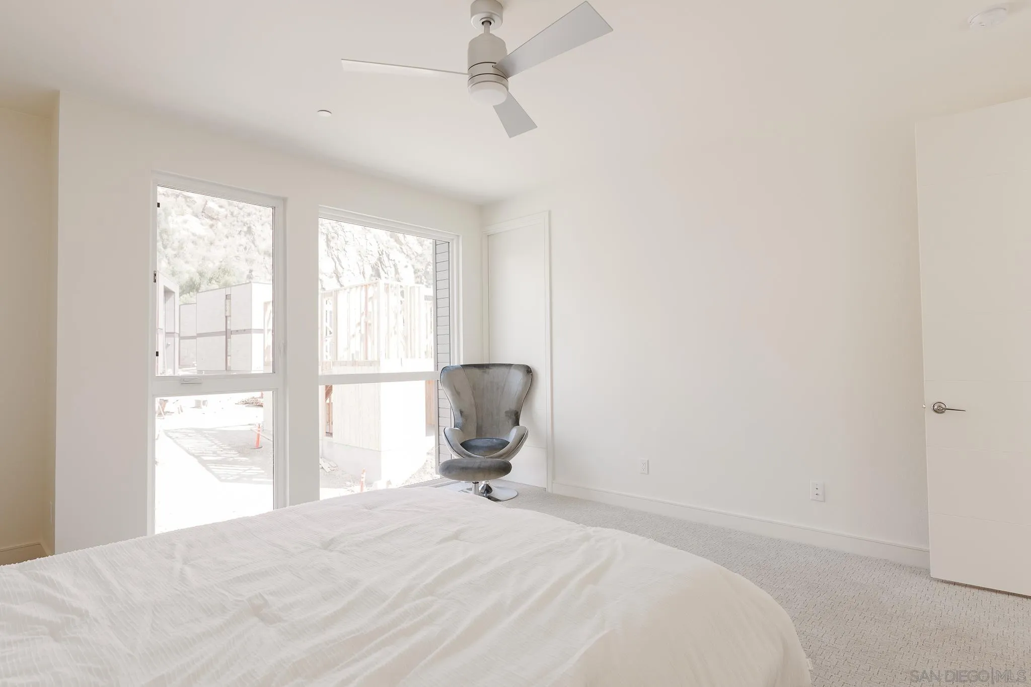 8286 High Street La Mesa, CA 91941 - Photo 18 of 27 a bedroom with a bed and a chair