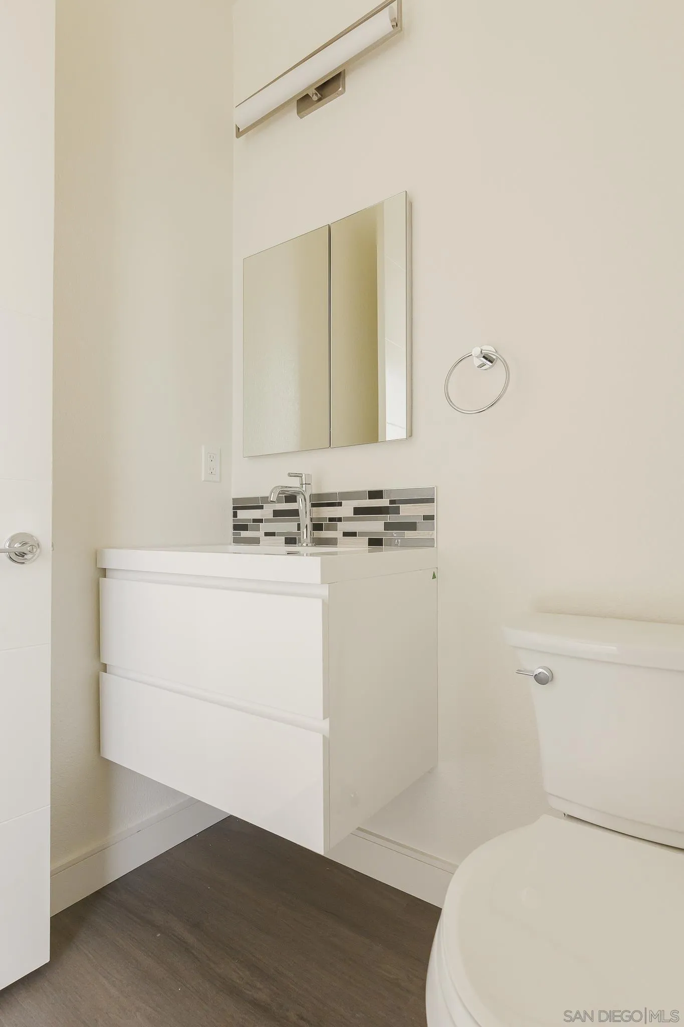 8286 High Street La Mesa, CA 91941 - Photo 7 of 27 a bathroom with a sink a toilet and a mirror