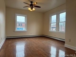 390 Main Street, Unit 3 Beacon, NY 12508 - Photo 6 of 8 Empty room featuring ceiling fan, wood-type flooring, and baseboards