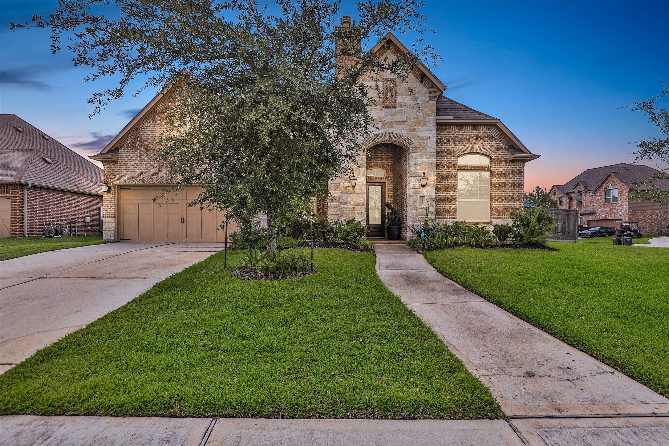 a front view of a house with a yard and garage