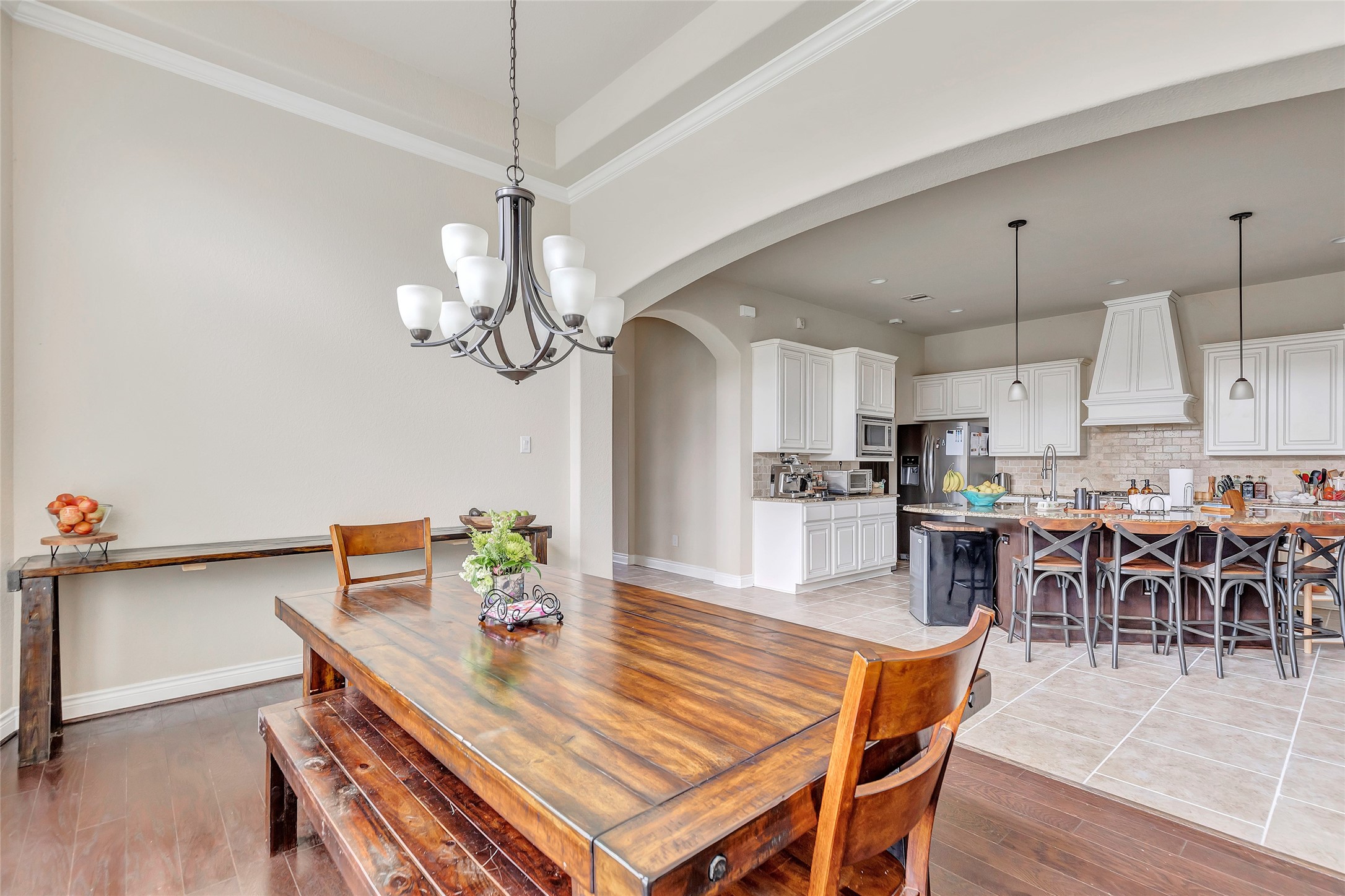 18115 Stari Most Lane Houston, TX 77044 - Photo 19 of 35 a dining room with wooden floor a chandelier a wooden table and chairs