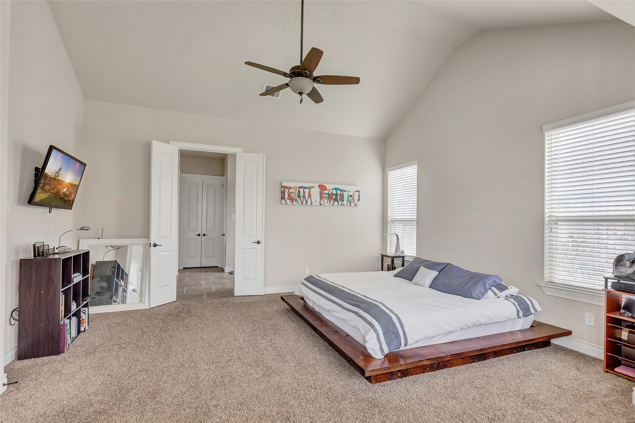 18115 Stari Most Lane Houston, TX 77044 - Photo 20 of 35 a bedroom with a bed and a flat tv screen on dresser