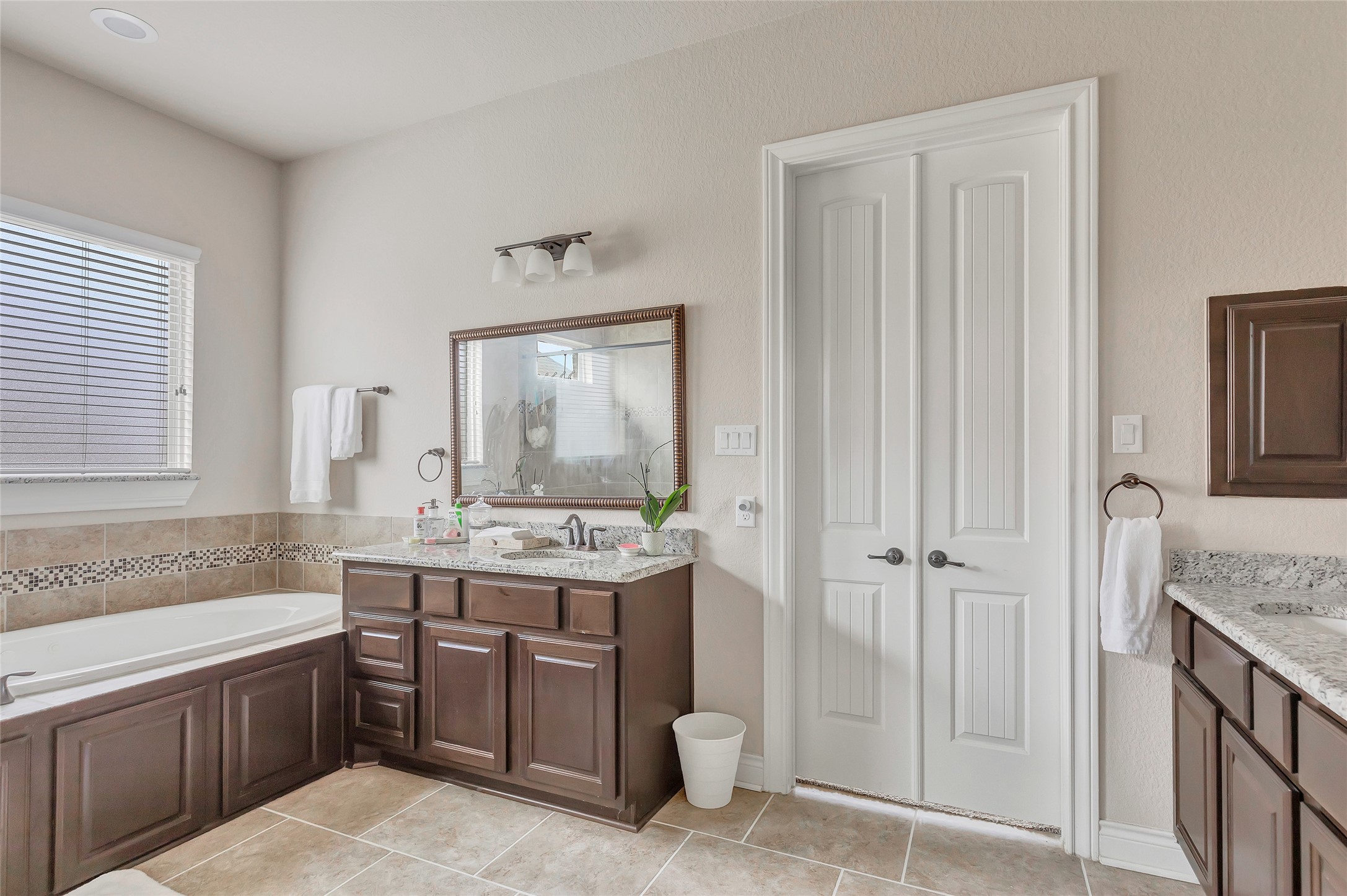18115 Stari Most Lane Houston, TX 77044 - Photo 23 of 35 a bathroom with a granite countertop sink a mirror and a bathtub