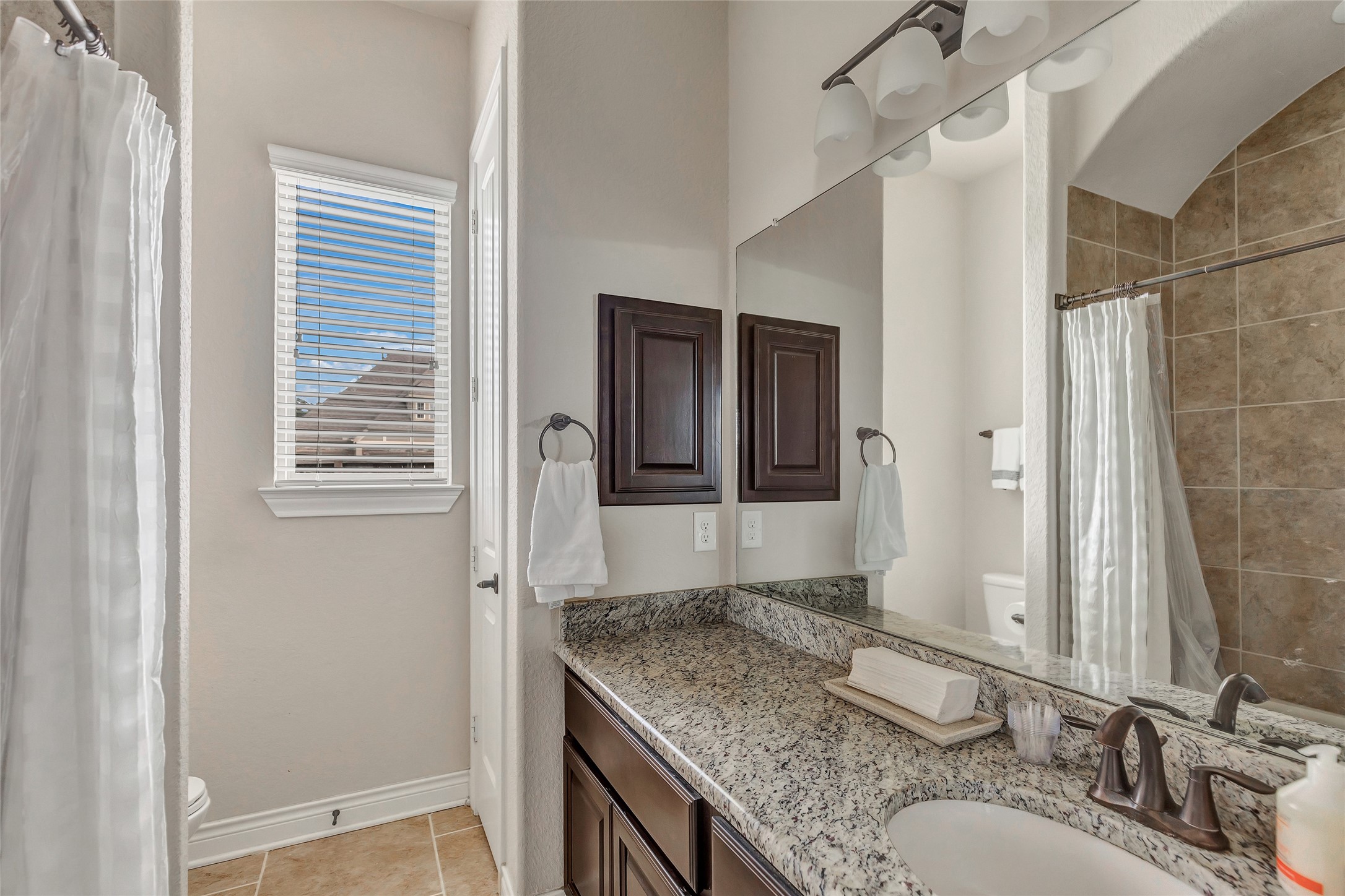 18115 Stari Most Lane Houston, TX 77044 - Photo 26 of 35 a bathroom with a granite countertop sink and a mirror