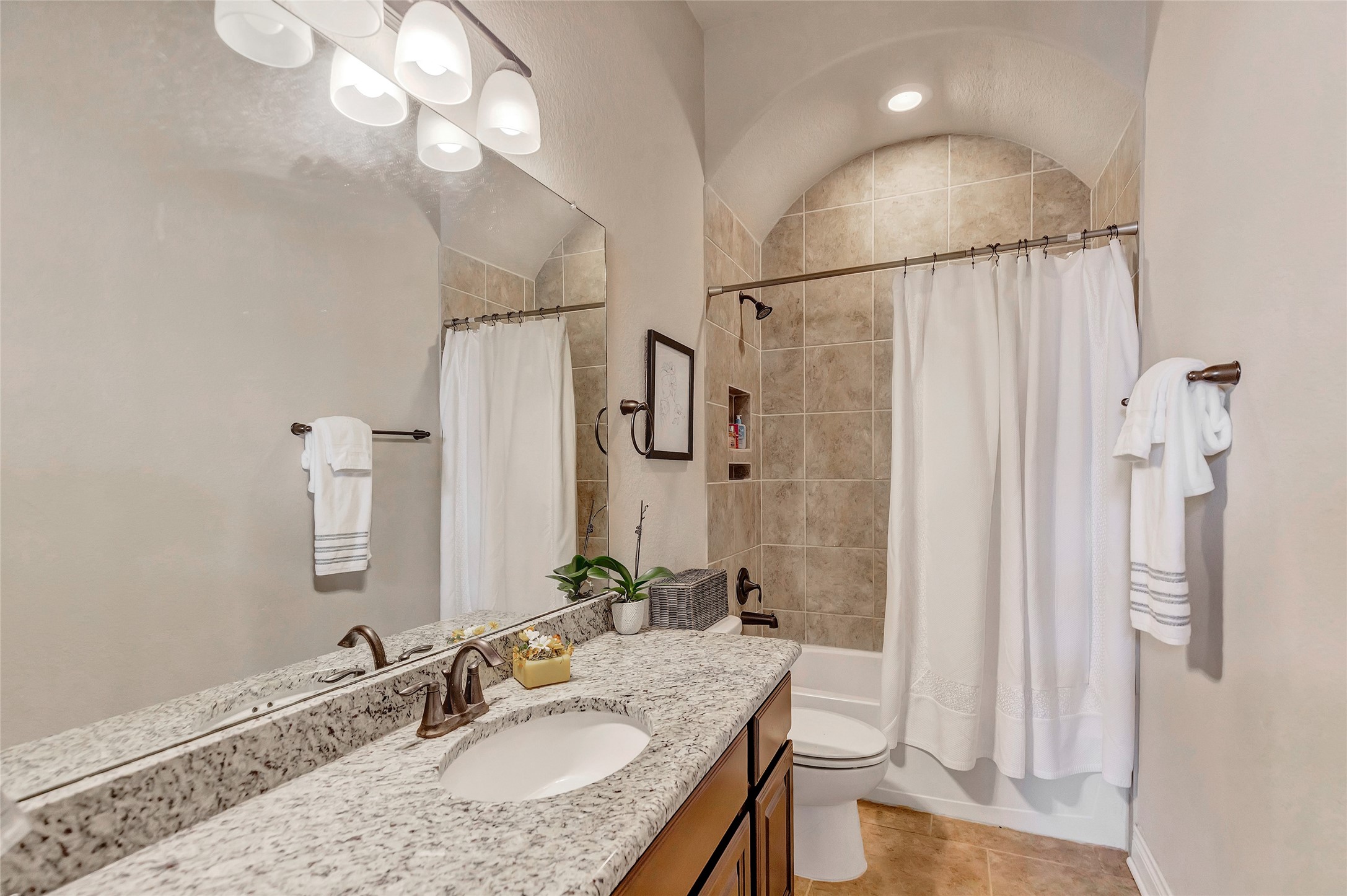 18115 Stari Most Lane Houston, TX 77044 - Photo 29 of 35 a bathroom with a granite countertop sink a toilet and shower a mirror