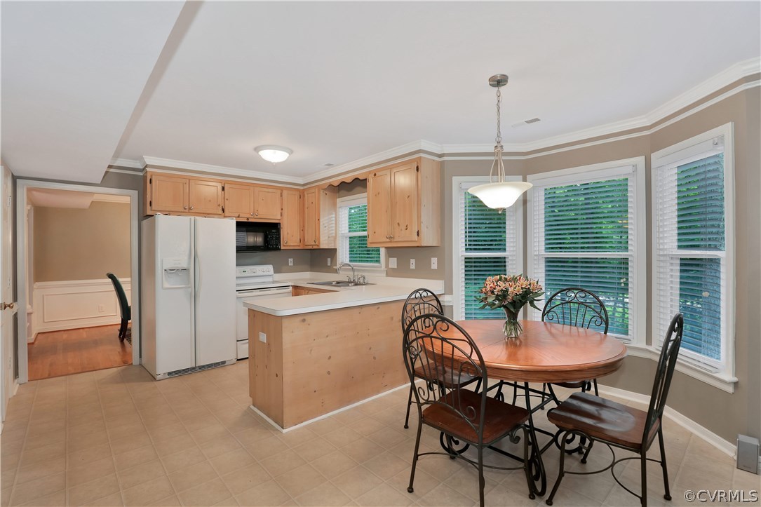 14602 Ridge Point Drive Midlothian, VA 23112 - Photo 11 of 25 a kitchen with refrigerator a sink and chairs
