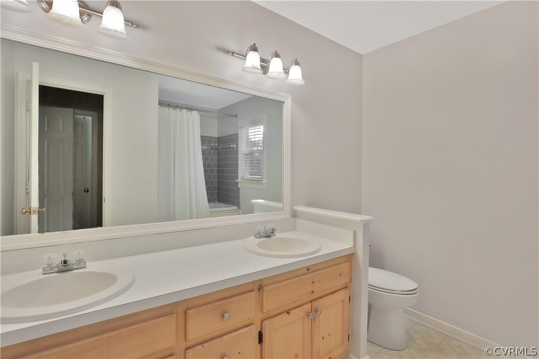 14602 Ridge Point Drive Midlothian, VA 23112 - Photo 19 of 25 a bathroom with a toilet a sink and mirror
