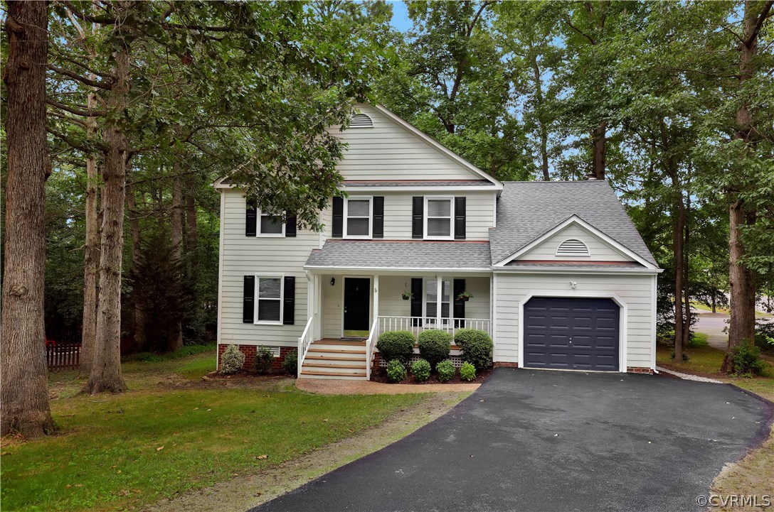 14602 Ridge Point Drive Midlothian, VA 23112 - Photo 2 of 25 a front view of a house with a garden and yard