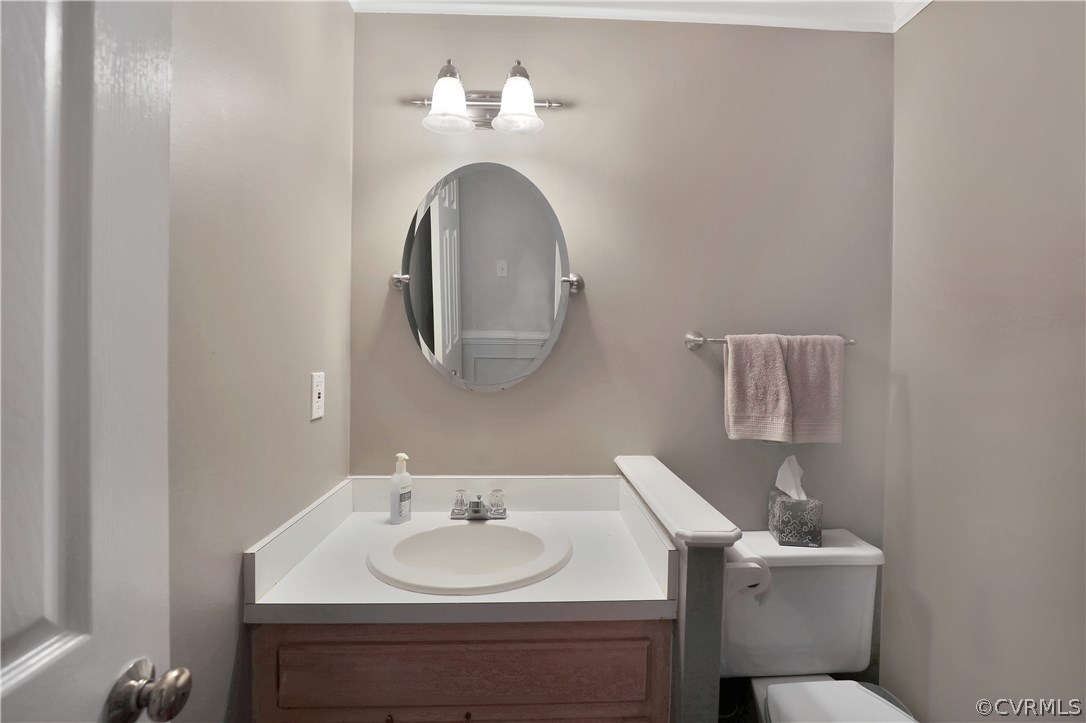 14602 Ridge Point Drive Midlothian, VA 23112 - Photo 8 of 25 a bathroom with a toilet sink and mirror