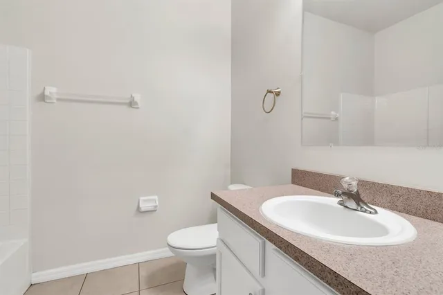 a bathroom with a sink toilet and a mirror