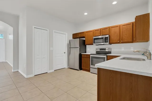 a kitchen with stainless steel appliances a refrigerator and a sink