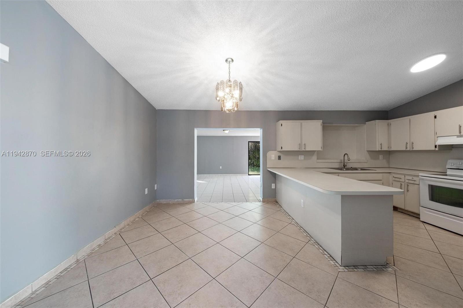 2348 Southwest 138th Place Miami, FL 33175 - Photo 13 of 35 a large kitchen with a stove a sink dishwasher and a refrigerator
