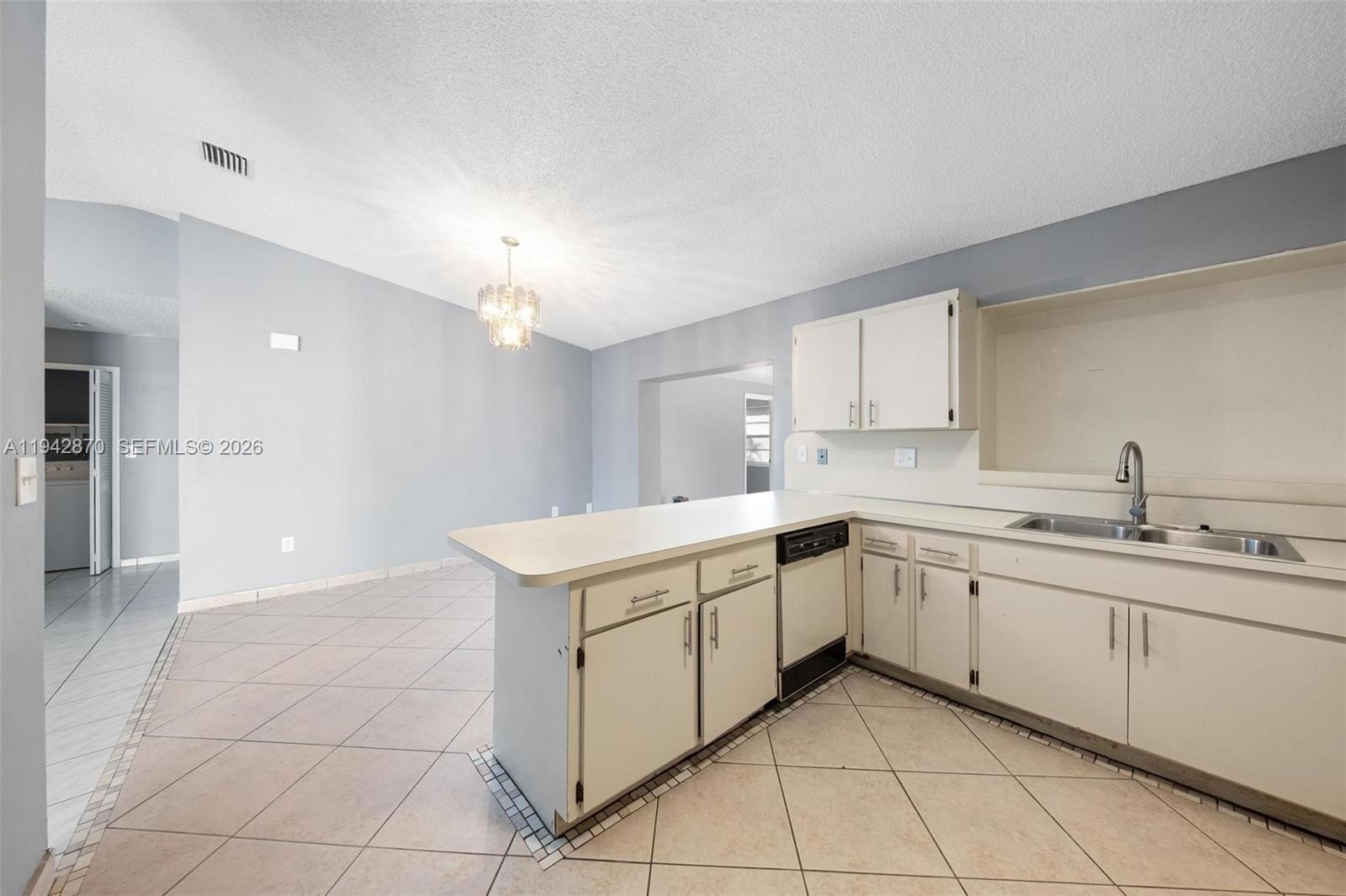 2348 Southwest 138th Place Miami, FL 33175 - Photo 15 of 35 a kitchen with a sink and cabinets