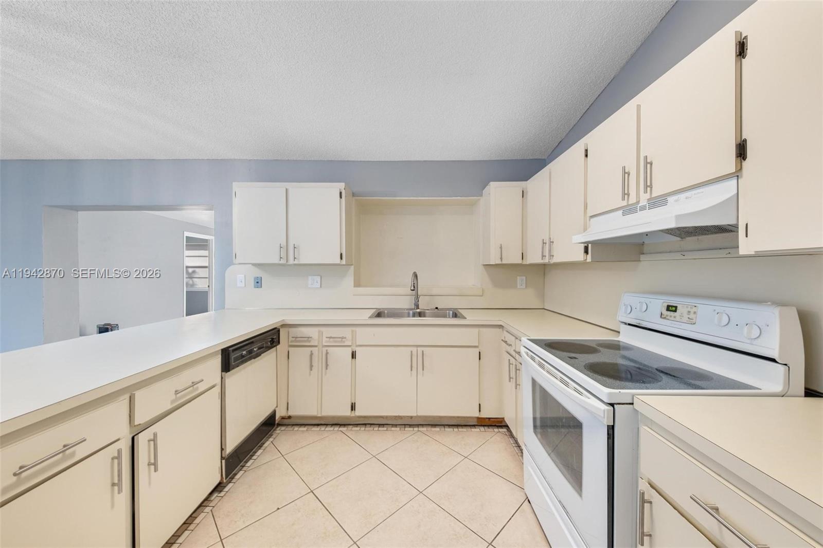 2348 Southwest 138th Place Miami, FL 33175 - Photo 16 of 35 a kitchen with cabinets appliances a sink and a counter top space