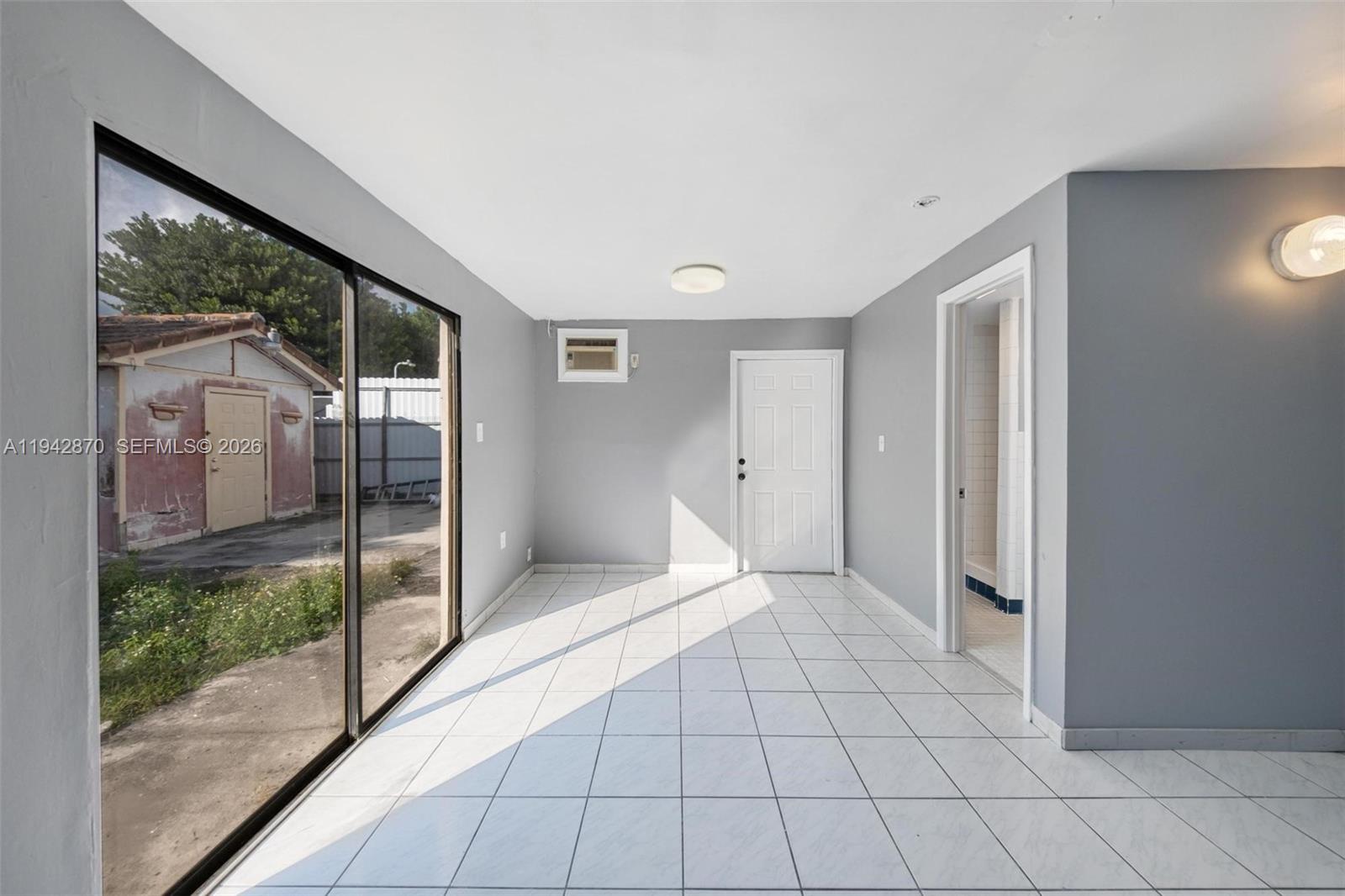 2348 Southwest 138th Place Miami, FL 33175 - Photo 21 of 35 a view of an empty room with sliding glass door
