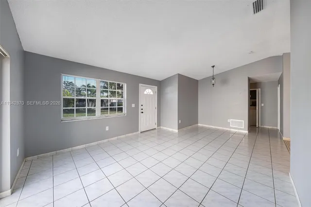a view of an empty room with a window