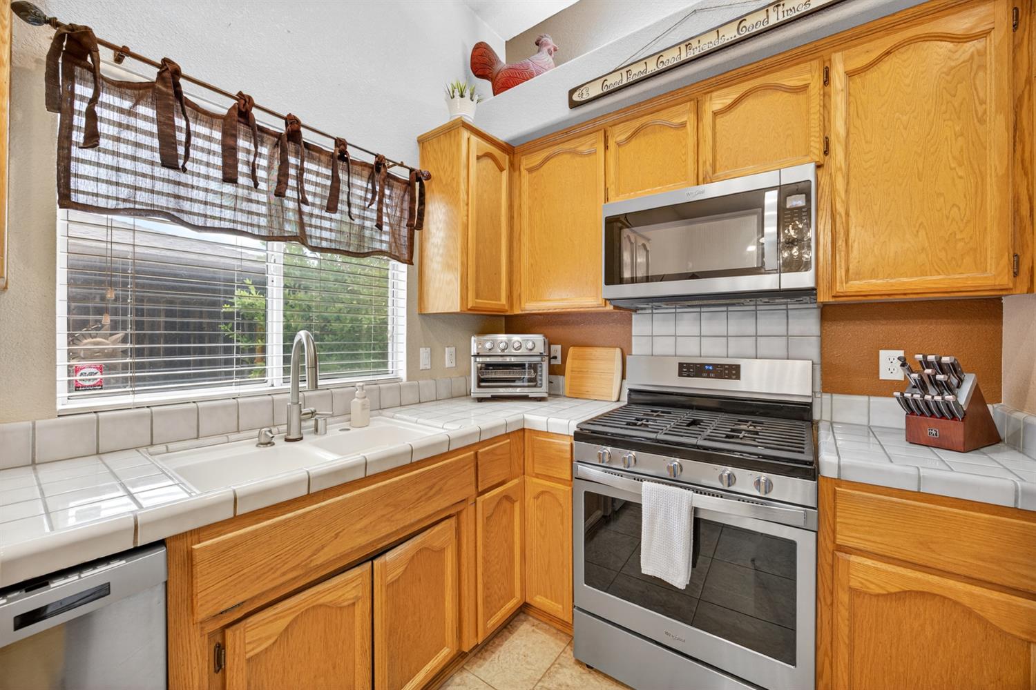 6113 Kifisia Way Fair Oaks, CA 95628 - Photo 16 of 67 a kitchen with stainless steel appliances a stove sink and cabinets