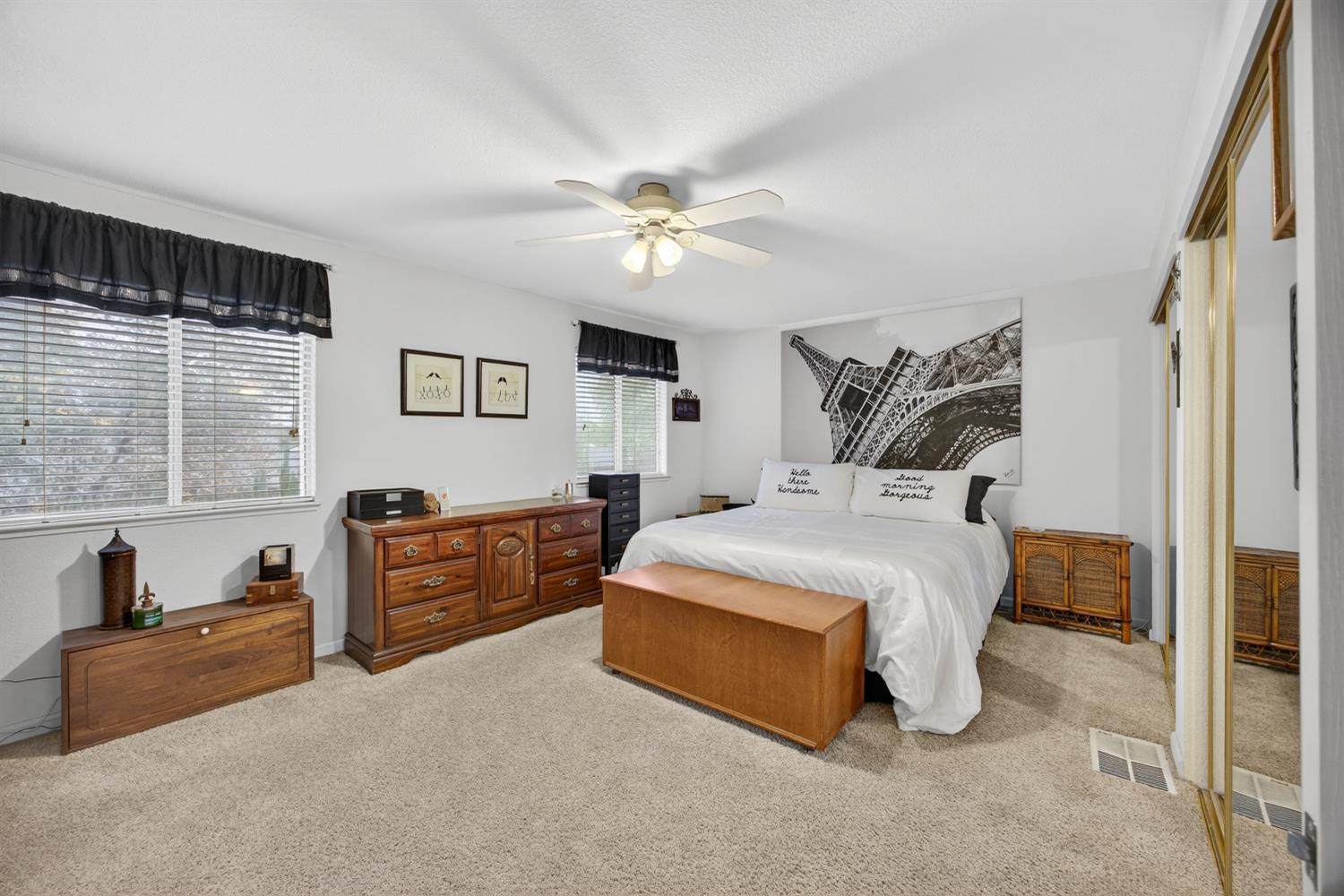 6113 Kifisia Way Fair Oaks, CA 95628 - Photo 26 of 67 a spacious bedroom with a bed and a chandelier