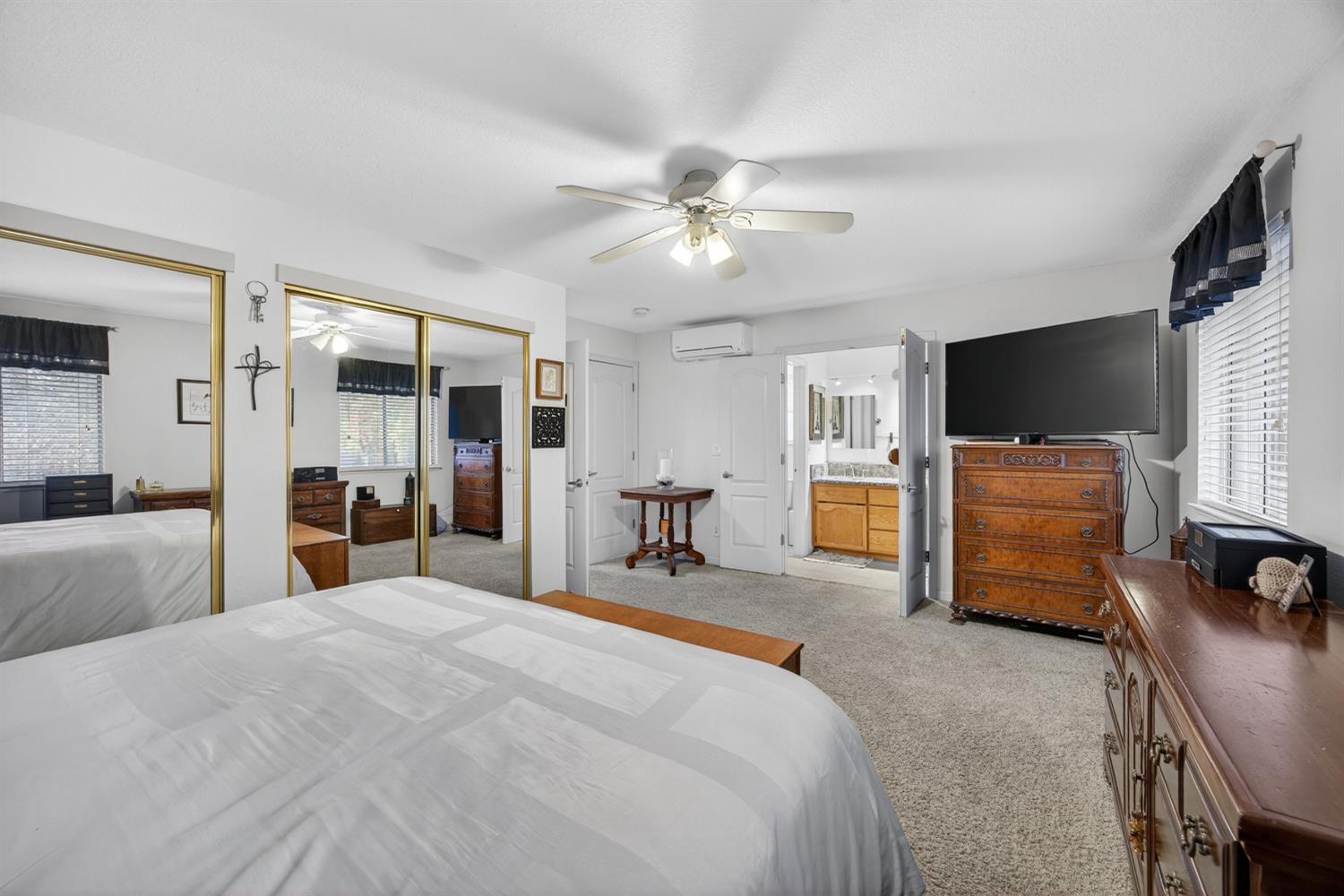 6113 Kifisia Way Fair Oaks, CA 95628 - Photo 27 of 67 a bedroom with a bed and a flat tv screen on dresser