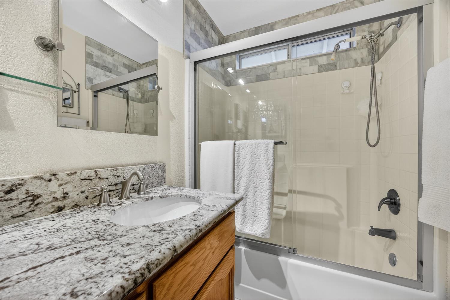 6113 Kifisia Way Fair Oaks, CA 95628 - Photo 30 of 67 a bathroom with a granite countertop sink mirror and shower