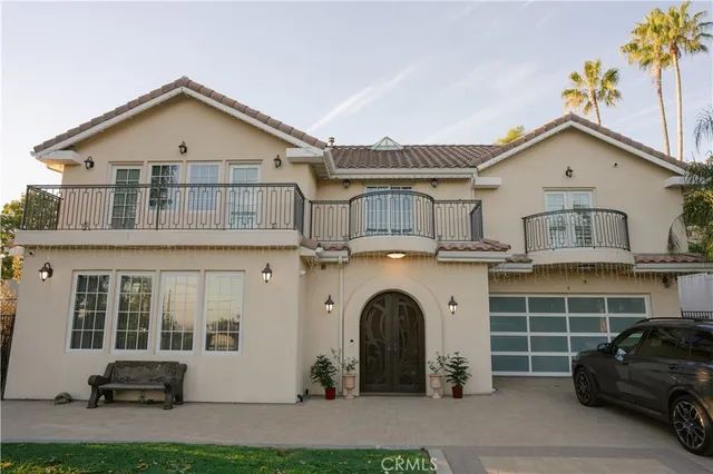 a view of a house with a barbeque grill and plants
