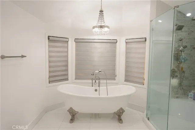 a bedroom with a bed and a flat tv screen on dresser