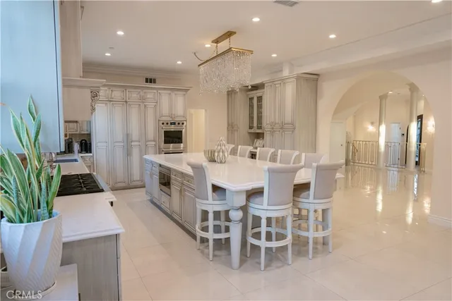 a large kitchen with a table and chairs