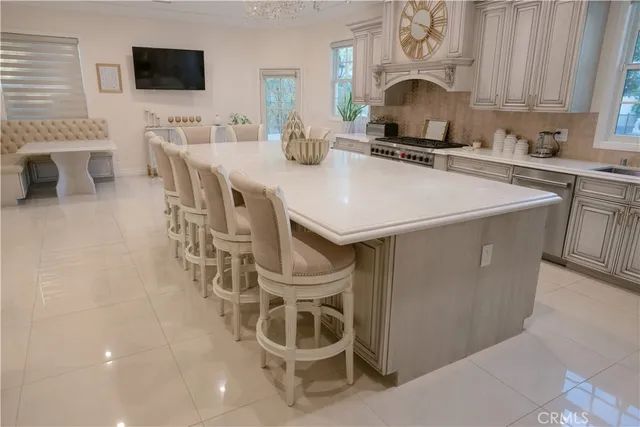 a kitchen with a sink a stove and chairs
