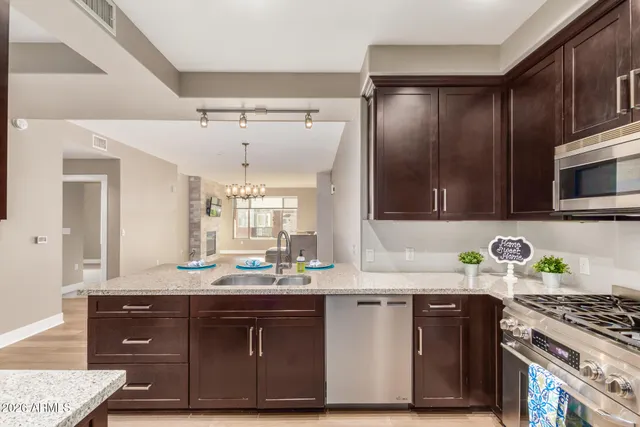 a bathroom with a granite countertop sink a mirror and cabinets