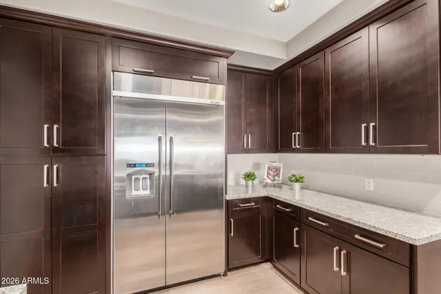 a kitchen with a refrigerator and a sink