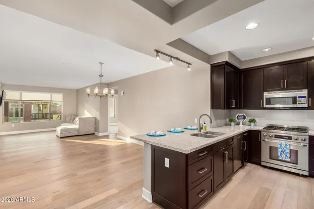 a kitchen with a sink stove top oven and cabinets