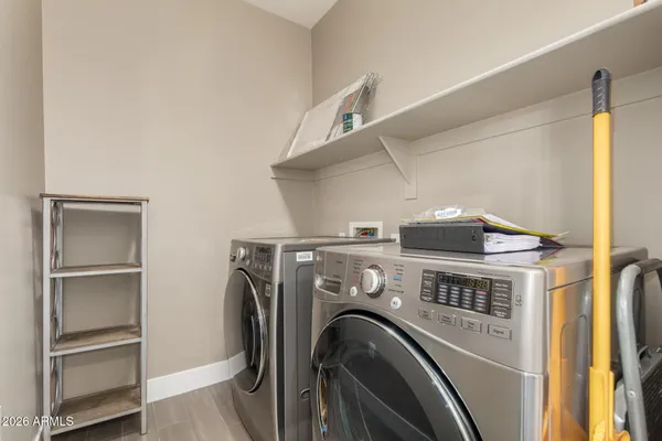 a view of washer and dryer with kitchen in the background