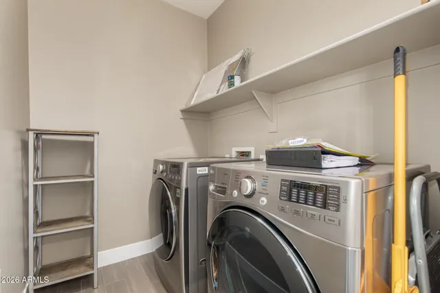 a view of washer and dryer with kitchen in the background