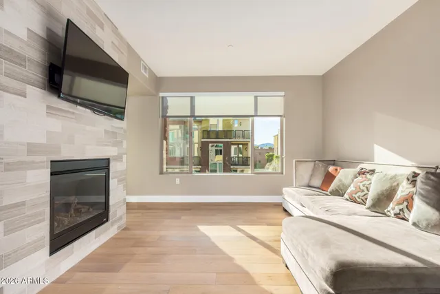 a living room with a flat screen tv and a fireplace