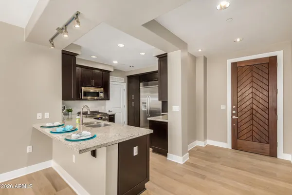 a kitchen with a sink appliances and cabinets