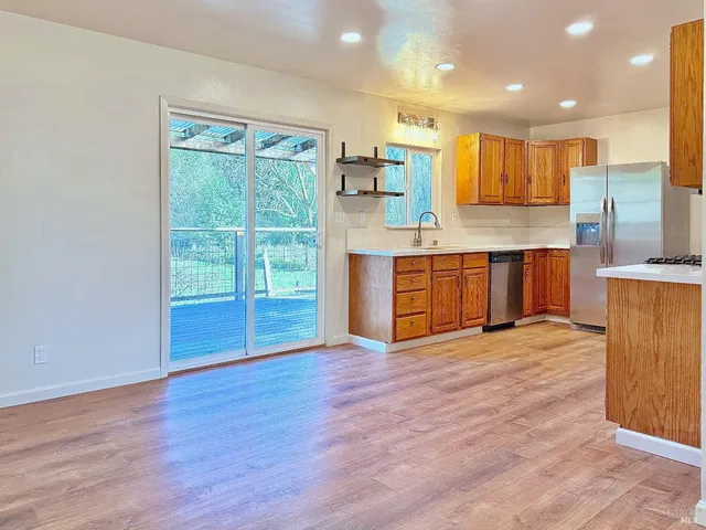 a view of kitchen with kitchen island wooden floor and window