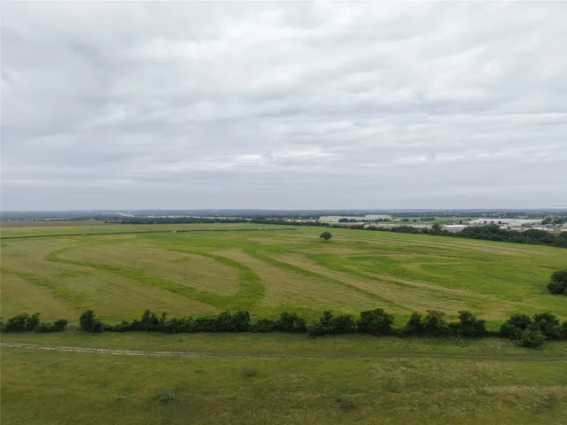 a view of a field with an ocean