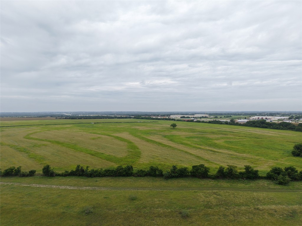 a view of a field with an ocean