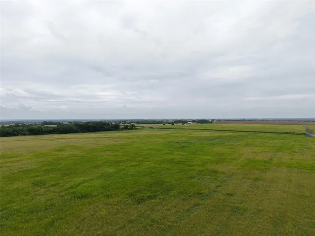 a view of a field with an ocean view
