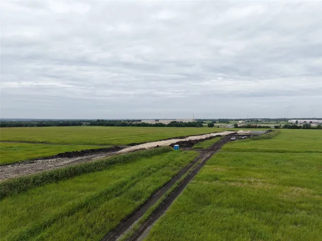 a view of a field with ocean view