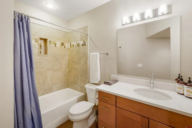 a bathroom with a sink toilet and shower