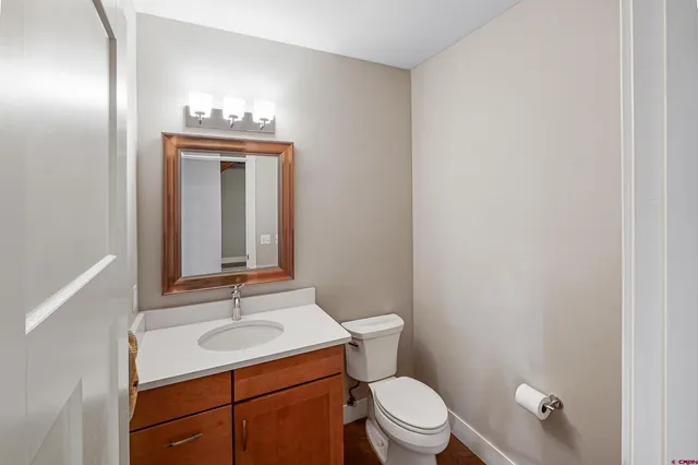 a bathroom with a sink a toilet and mirror