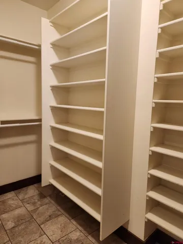 a view of walk in closet with empty racks