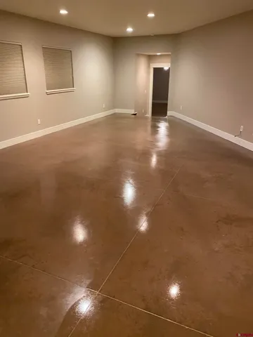 a view of an empty room with window and cabinet