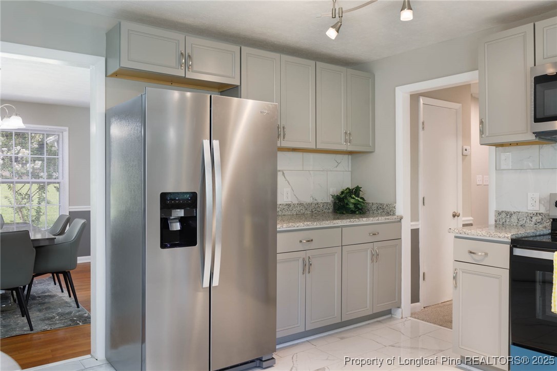 2419 Morganton Road Fayetteville, NC 28303 - Photo 11 of 44 a kitchen with stainless steel appliances a refrigerator sink and cabinets