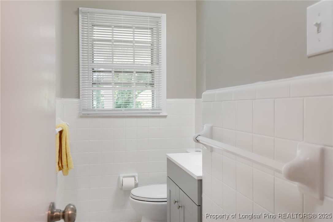 2419 Morganton Road Fayetteville, NC 28303 - Photo 16 of 44 a white toilet sitting next to a bath tub