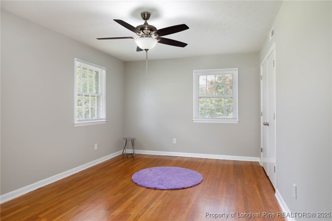 2419 Morganton Road Fayetteville, NC 28303 - Photo 21 of 44 an empty room with wooden floor and windows